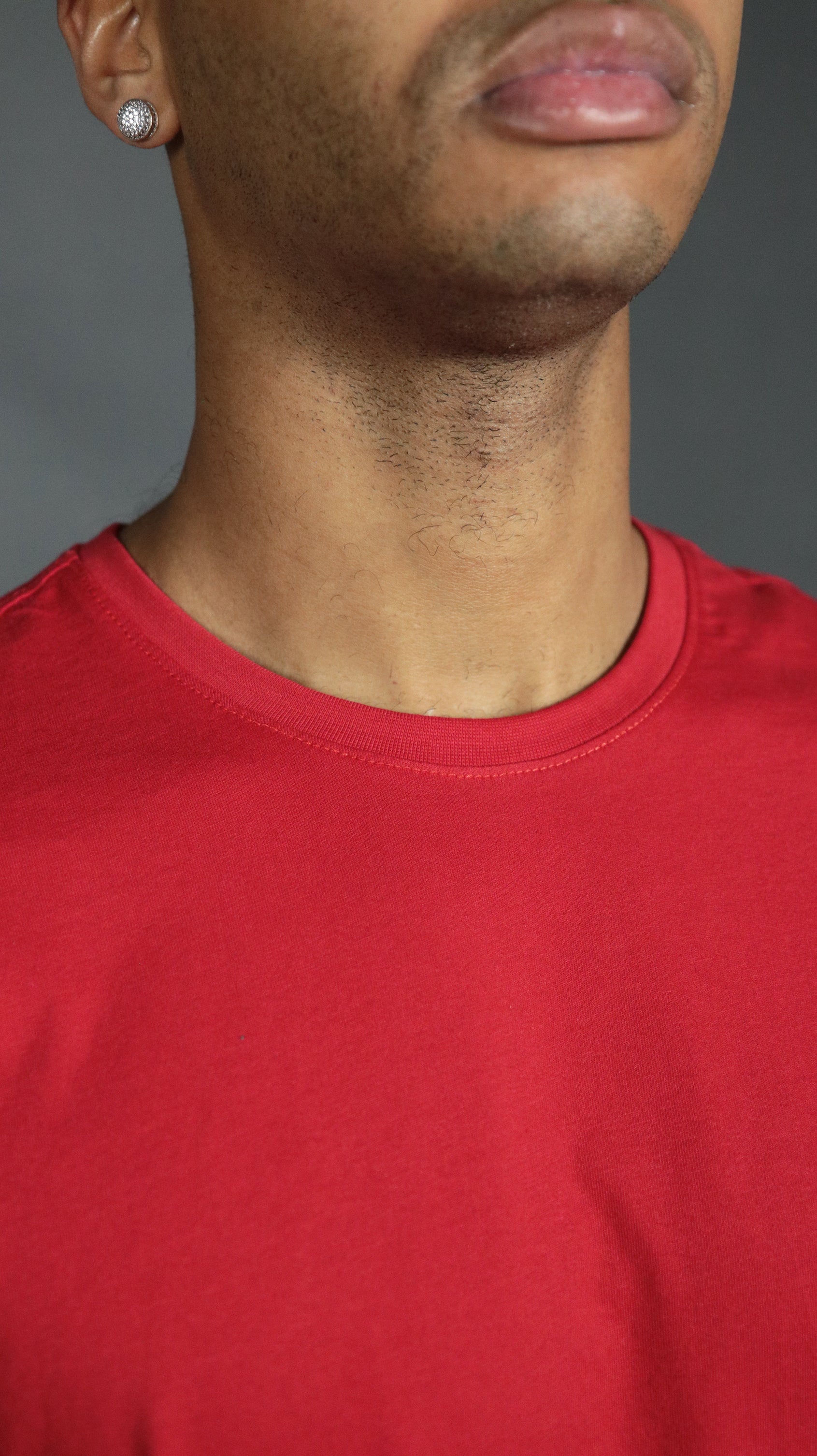 Front design of the red Jordan Craig longline scoop bottom shirt.