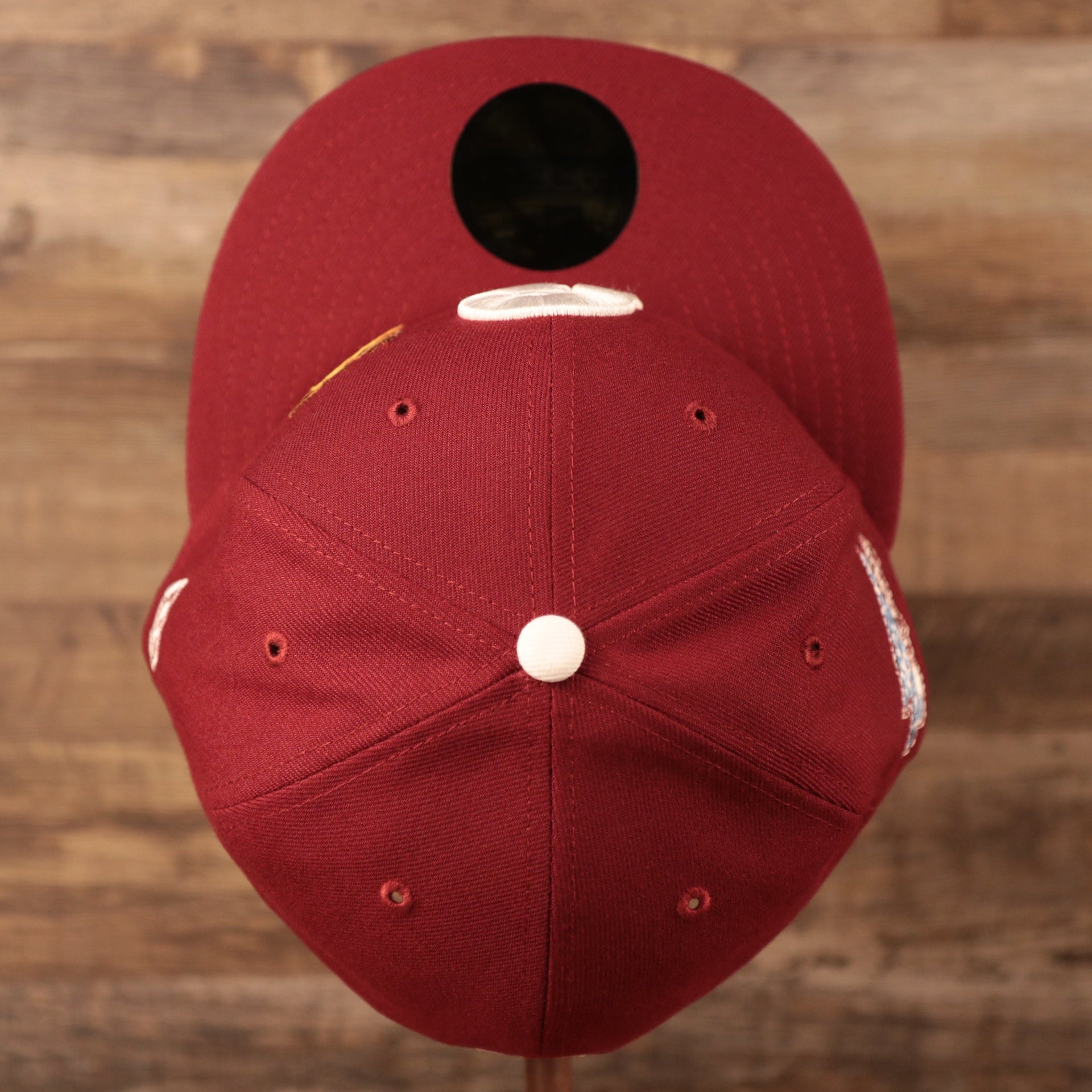 A top view of the crown of the Philadelphia Phillies grey bottom maroon 59fifty hat by New Era.
