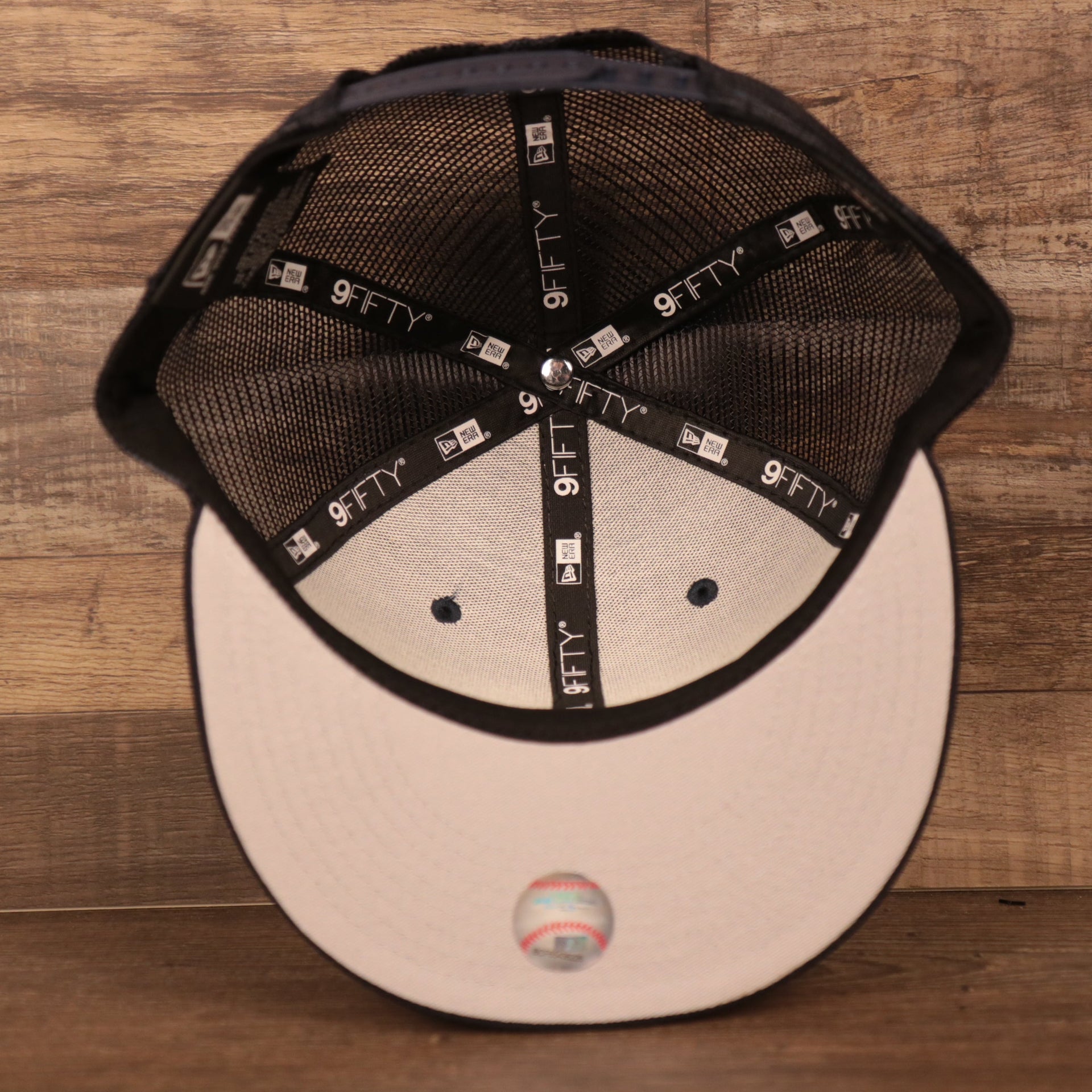 An inside look of the gray bottom brim mesh snapback hat for the Yanks.