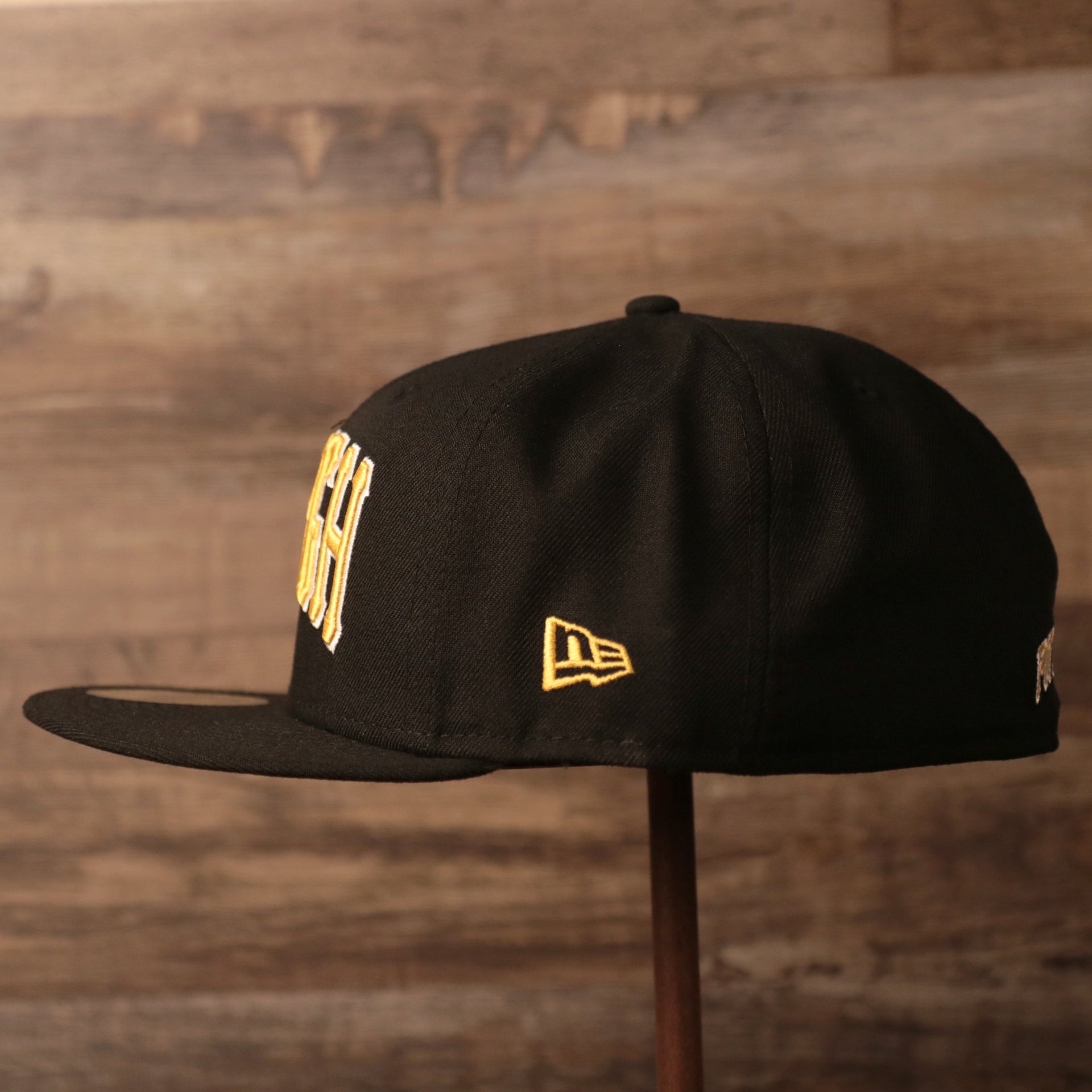 The right side of the black retro New Era fitted hat for the Pittsburgh Pirates.