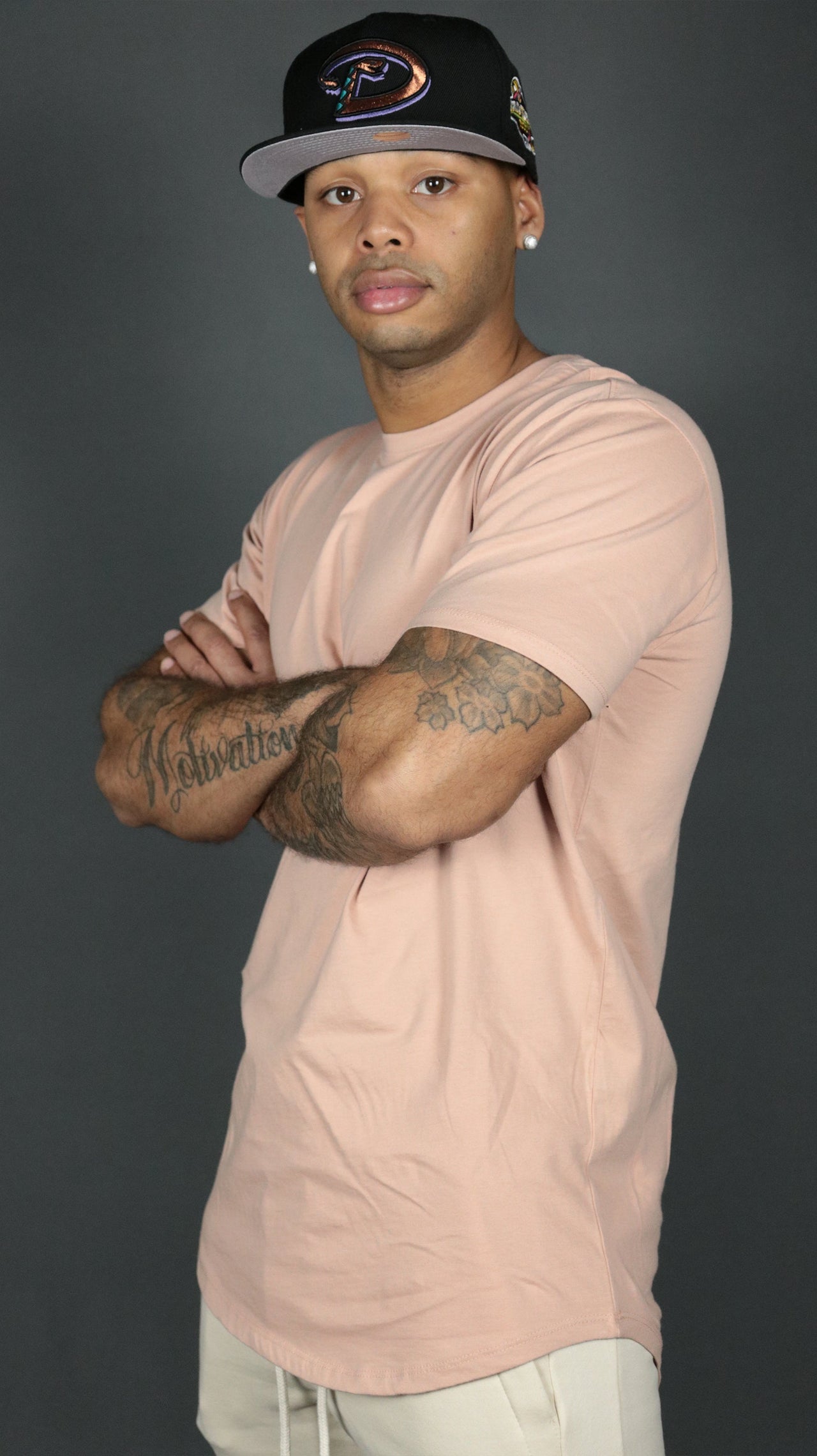 A model wearing the pink Jordan Craig drop cut t shirt for men.