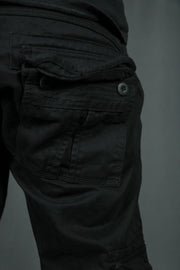 A buttoned pocket on the back side of the black Jordan Craig cargo joggers.