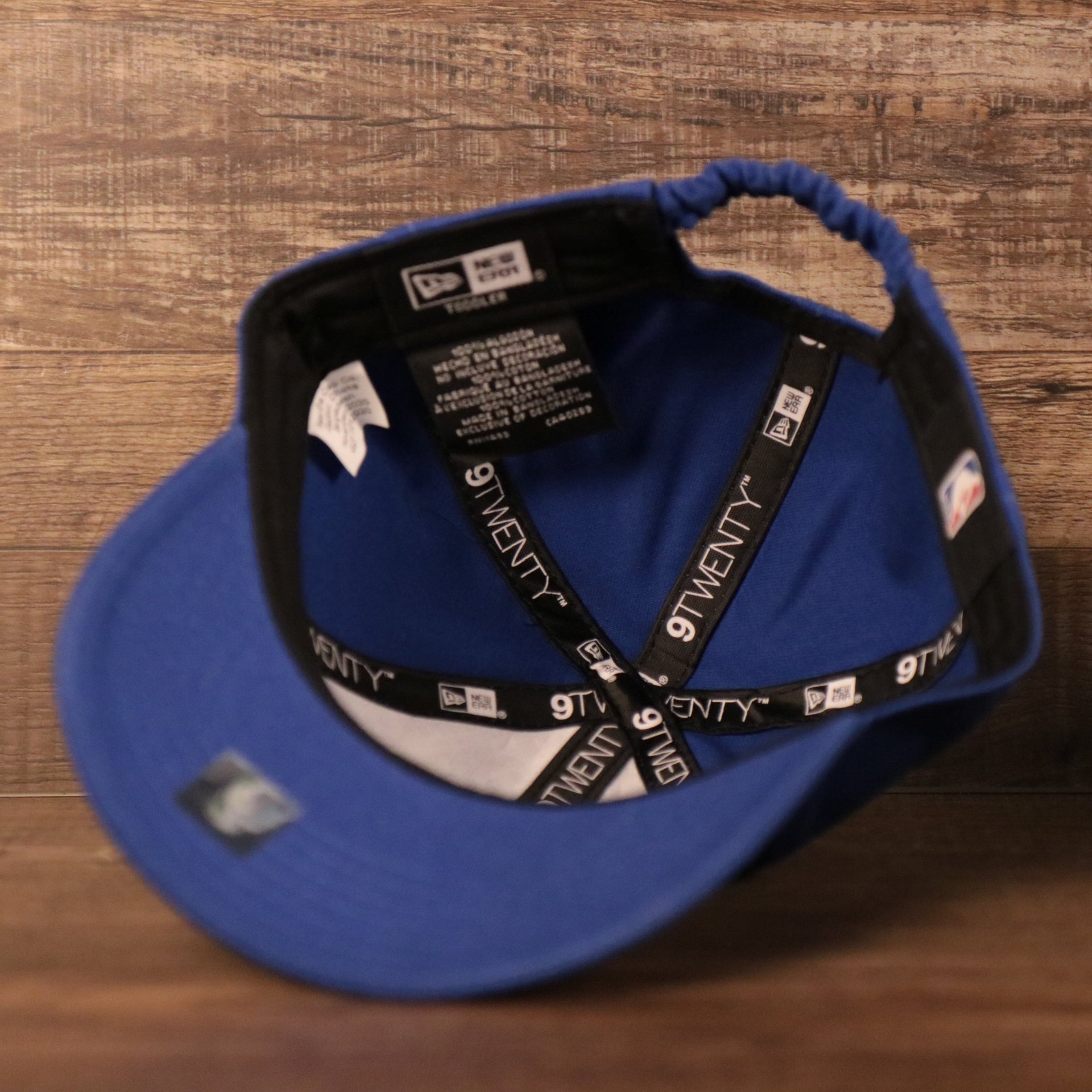 An inside view of the crown of the royal blue infant baseball cap for the Philadelphia 76ers.