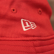 A closeup shot of the white New Era patch on the red Houston Rockets bucket hat.