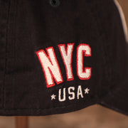 A closeup shot of the NYC USA patch on the wearer's right side of the navy MLB fourth of July 2021 Yankees 920 dad hat.