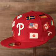 all of the flags on this phillies cap represent a country in the MLB Phillies World Flags Gray Bottom Fitted Cap | Philadelphia Phillies International Flags Red Grey Under Brim Fitted Cap