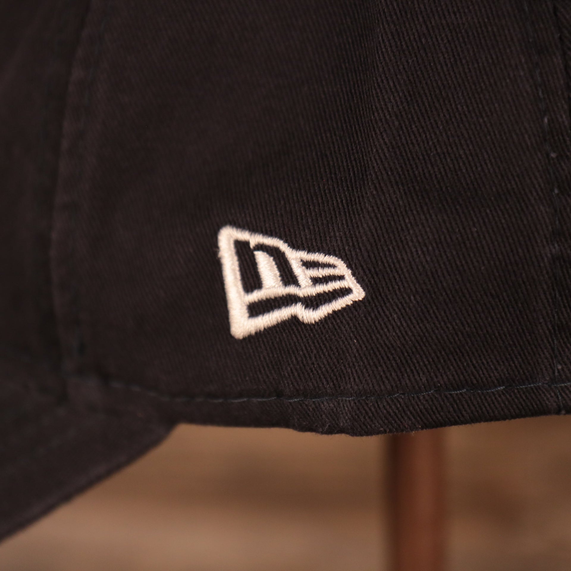A closeup shot of the white New Era patch on the left side of the navy 2021 fourth of July 9twenty dad hat for the New York Yankees by New Era.