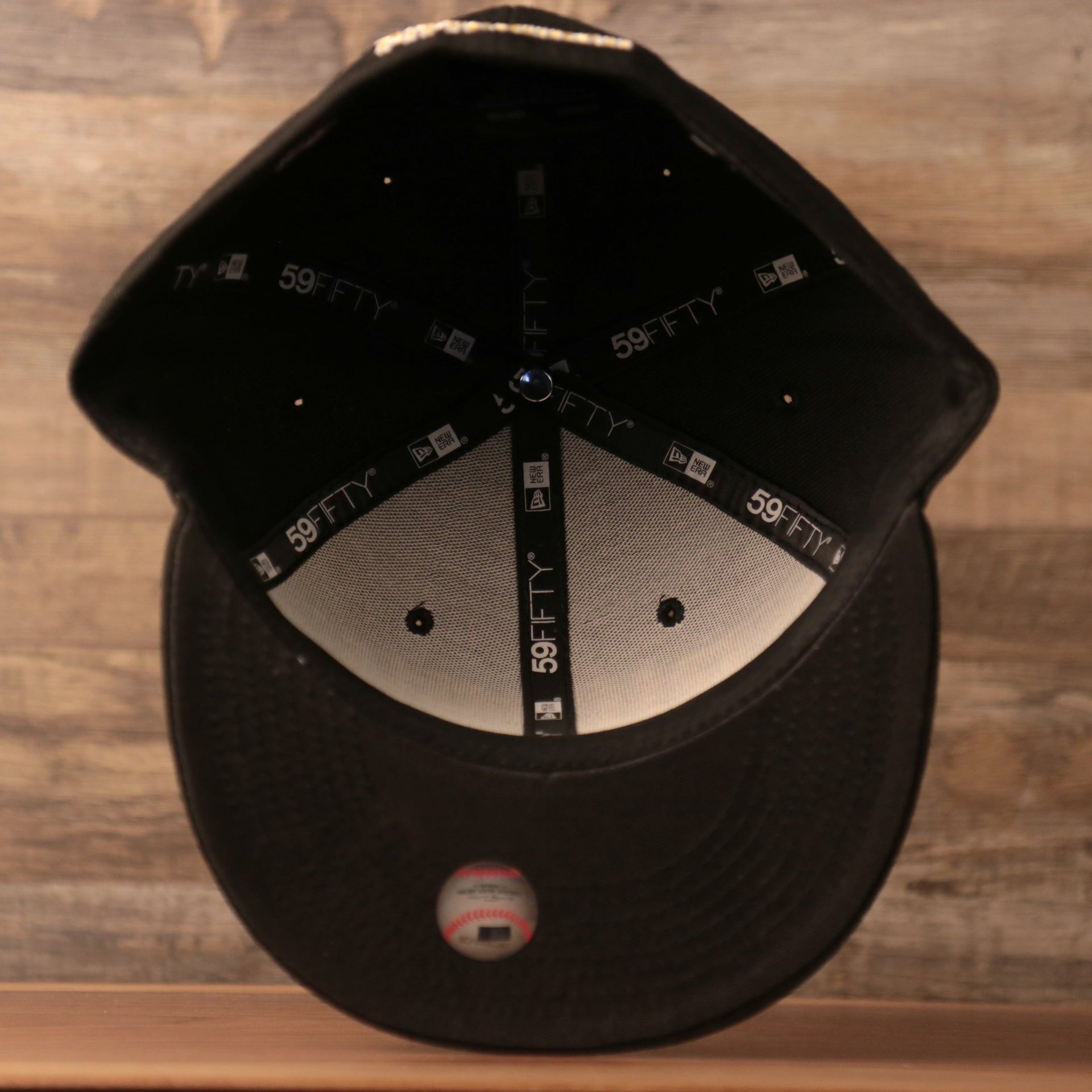 The inside of the black bottom brim side patch fitted cap by New Era.