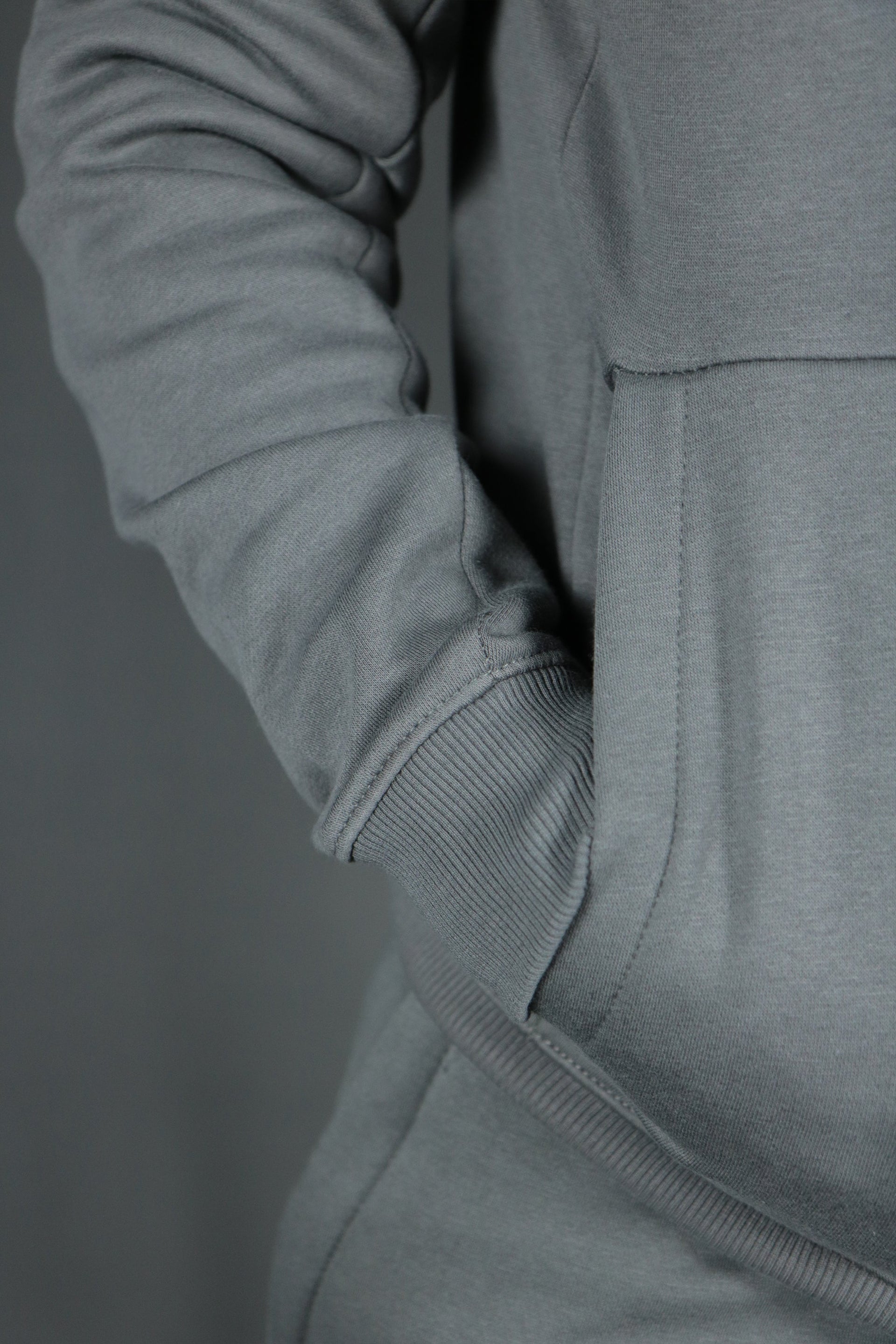 One of the two pockets of the charcoal basic tech fleece hoodie by Jordan Craig.