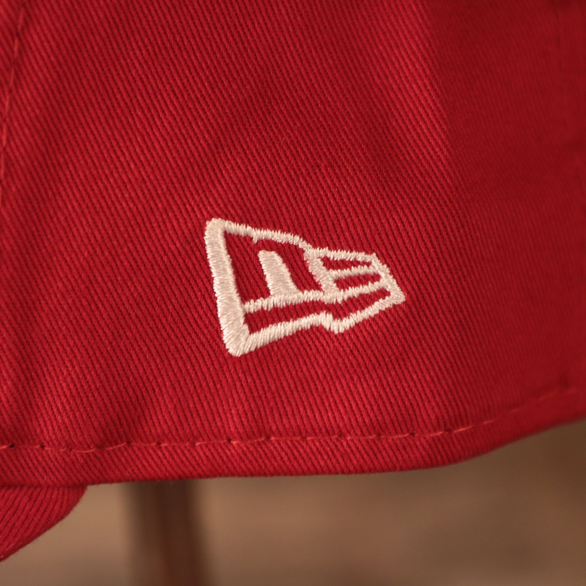 A closeup shot of the white New Era patch on the left side of the red 2021 fourth of July 9twenty dad hat for the Philadelphia Phillies by New Era.