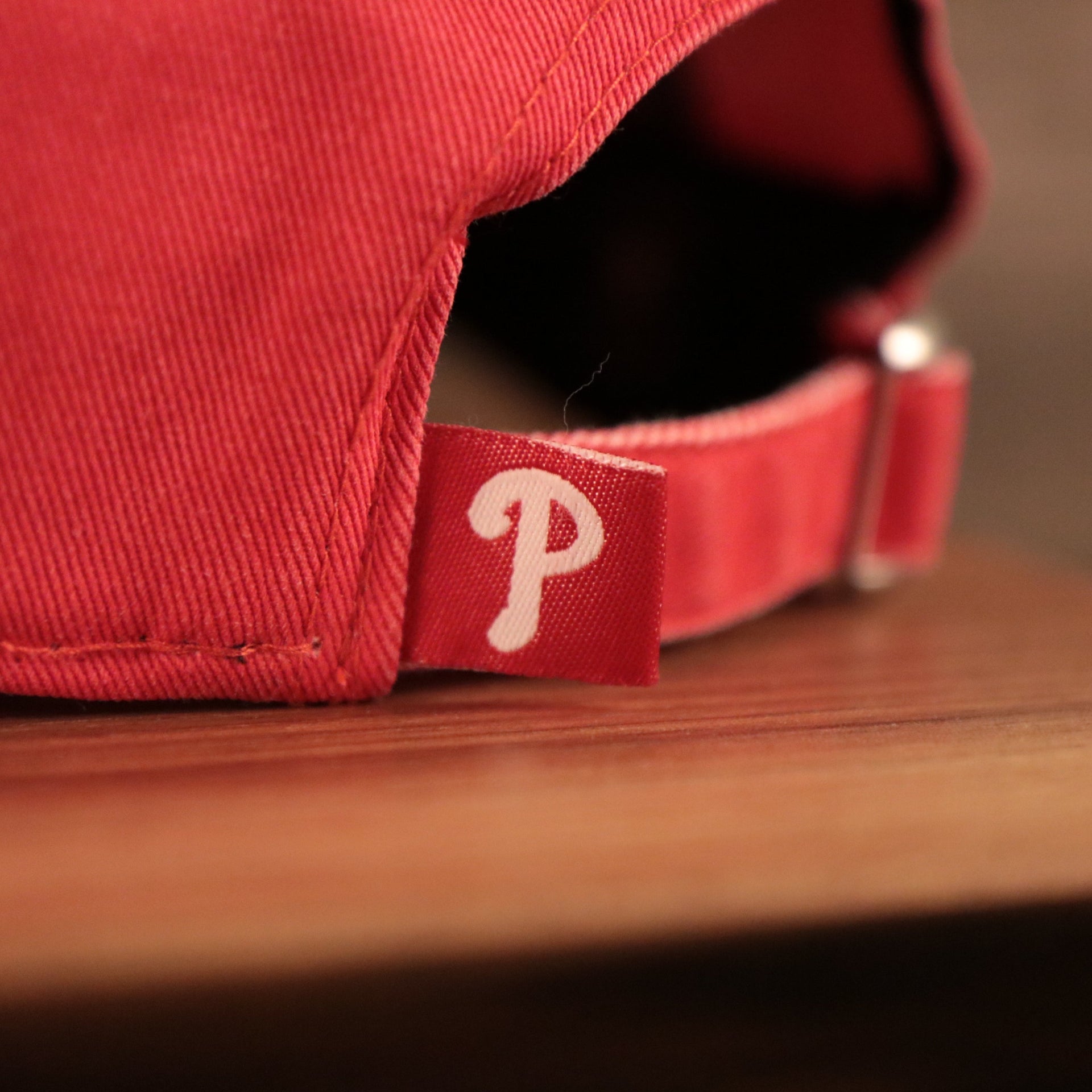 The Phillies strap on the backside of the New Era washed pink womens 920 baseball cap.