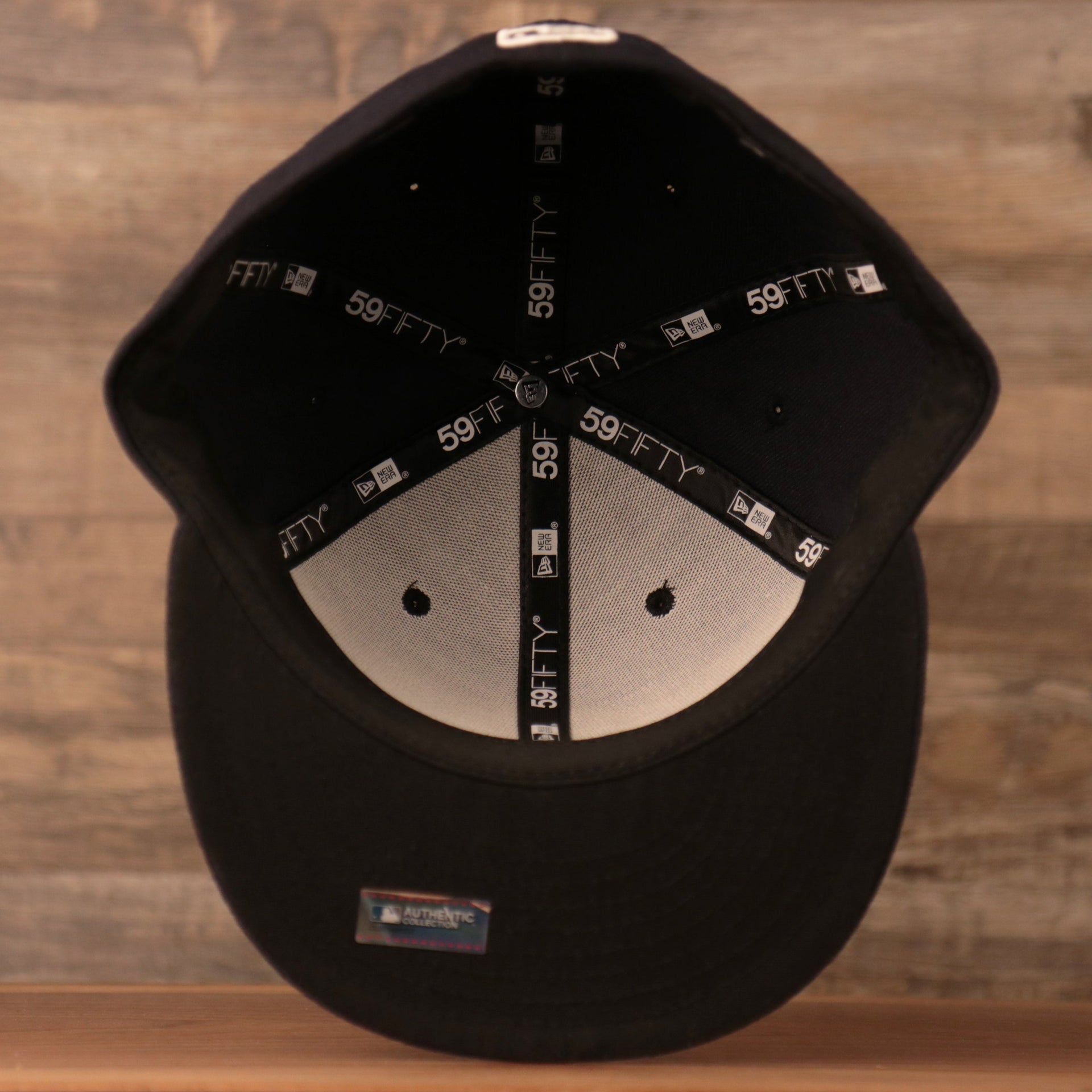 Bottom View of the Yankees Black Bottom on Field 59Fifty which has the 59Fifty taping around it