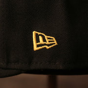 The gold New Era logo on the left side of the black Pittsburgh Pirates fitted cap by New Era.