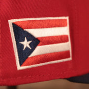 The right side of the red coqui fitted cap has the Puerto Rico logo.