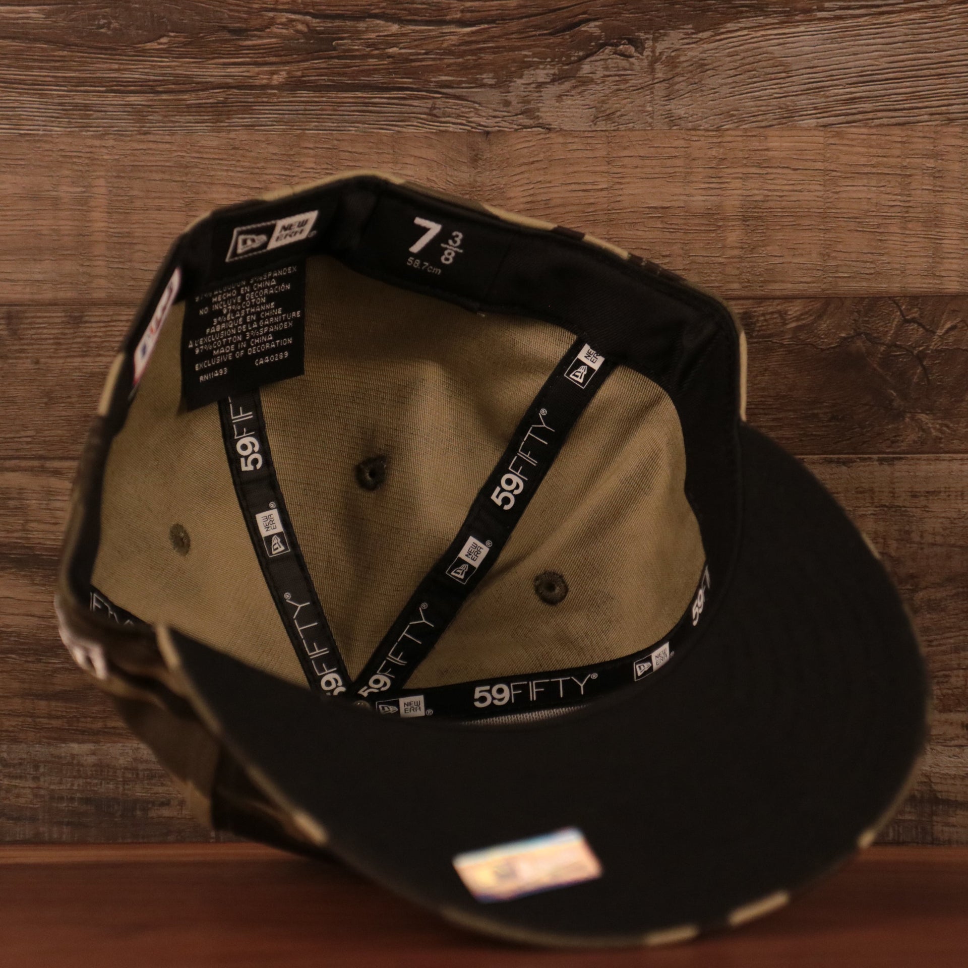 The inside view of the crown of the black bottom fitted 2021 Phillies military hat by New Era.