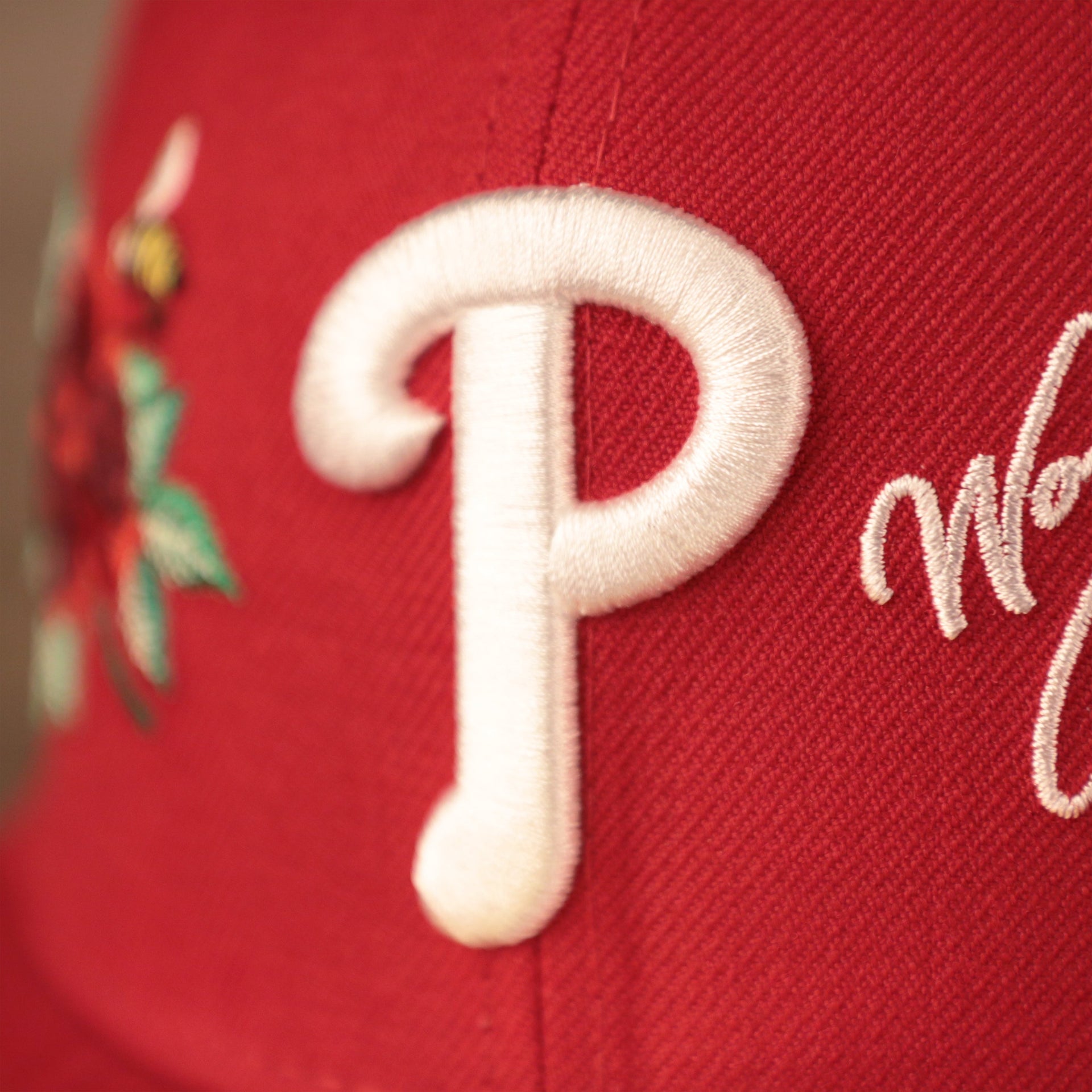 The white Phillies logo on the front side of the red all over patch fitted 59fifty.