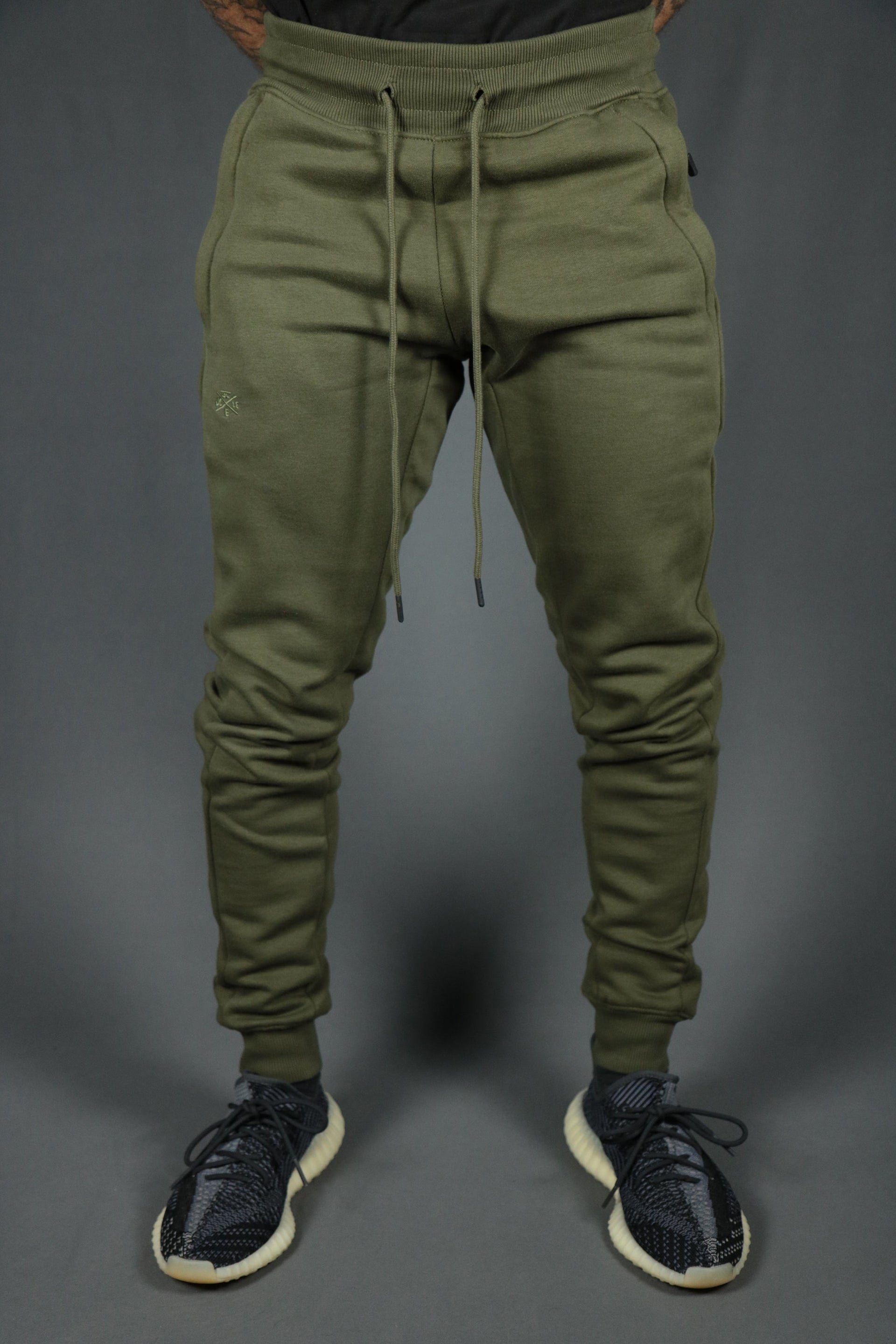 The basic fleece military green jogger pants with logo trim bottom by Jordan Craig.