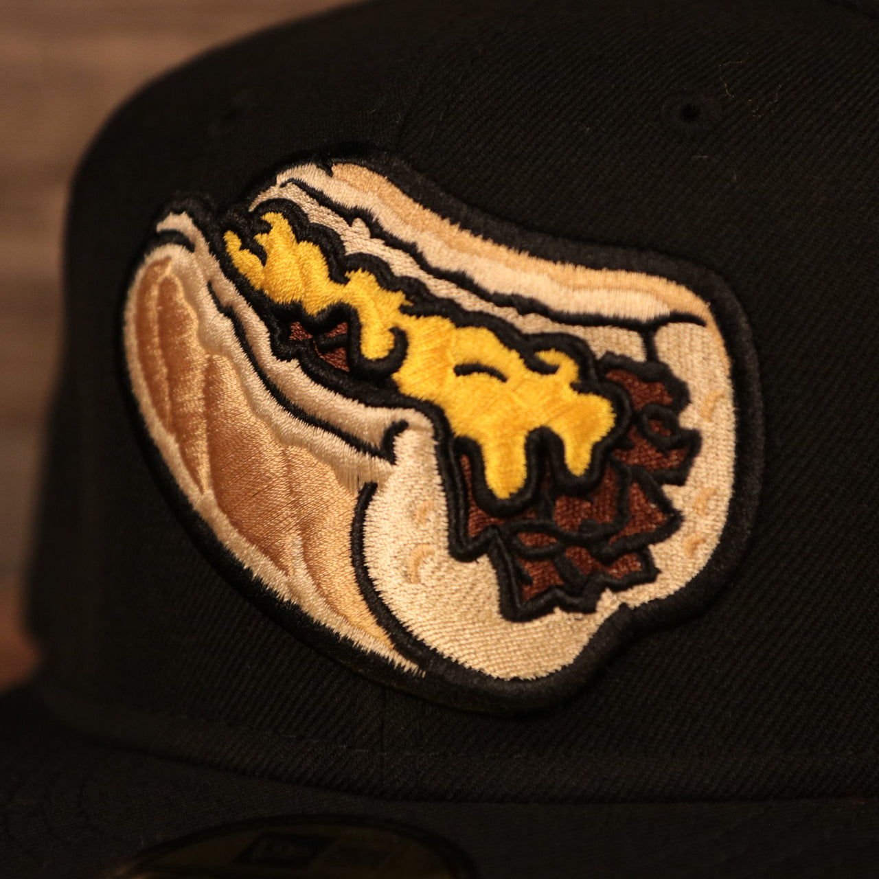 The Philly cheesesteak without onions patch on the front side of the gray brim fitted New Era 59fifty.