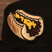 The Philly cheesesteak without onions patch on the front side of the gray brim fitted New Era 59fifty.
