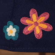 Two flower crotchet patches on the back left of the Los Angeles Dodgers All Over Floral Pattern Flower Crotchet Side Patch Pink Bottom 59Fifty Fitted Cap