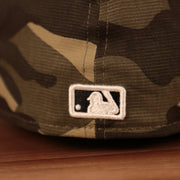 The MLB logo on the back side of the Yankees woodland camo 2021 Armed Forces Day hat.