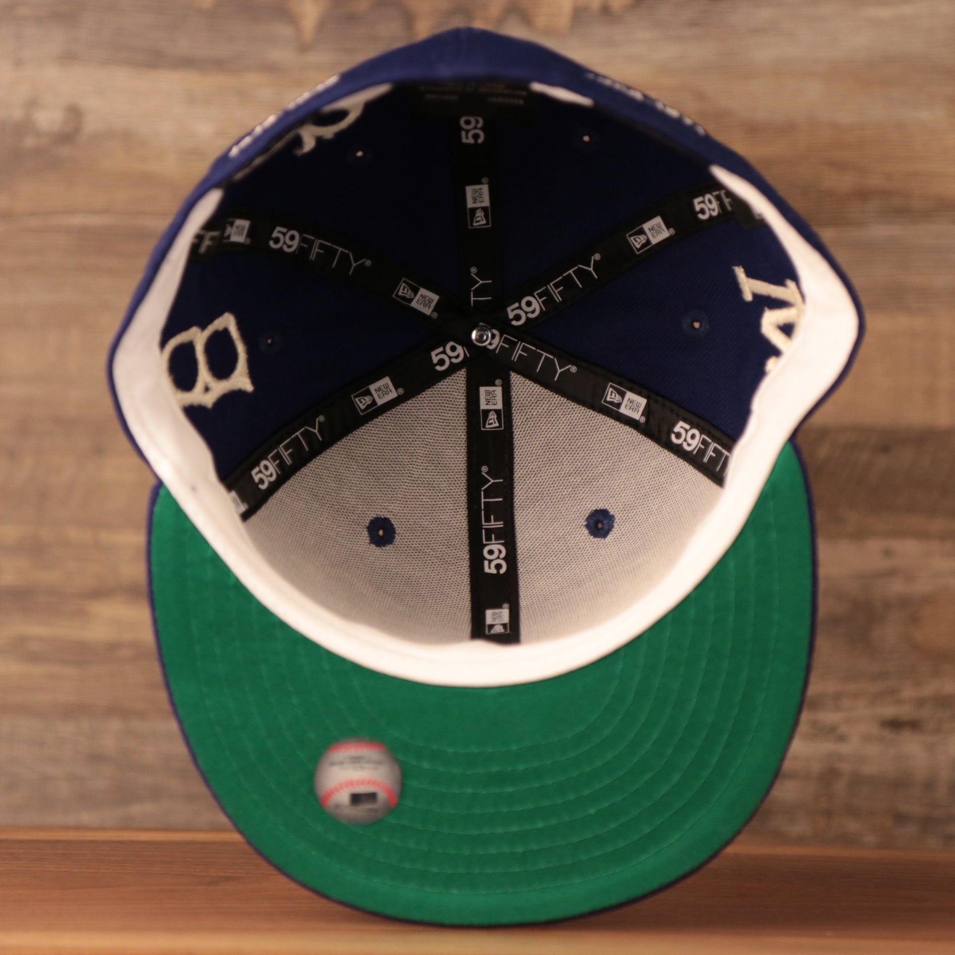 The blue New Era 59fifty has a cool green underbrim.