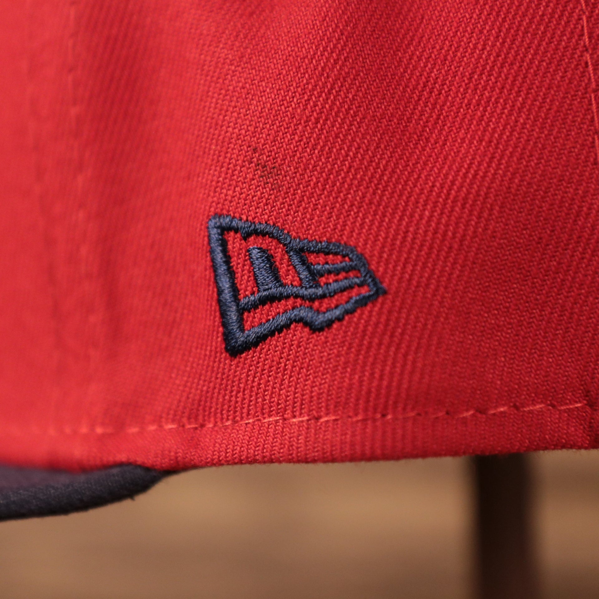 The New Era logo on the left side of the red coqui fitted cap for the MiLB Copa.
