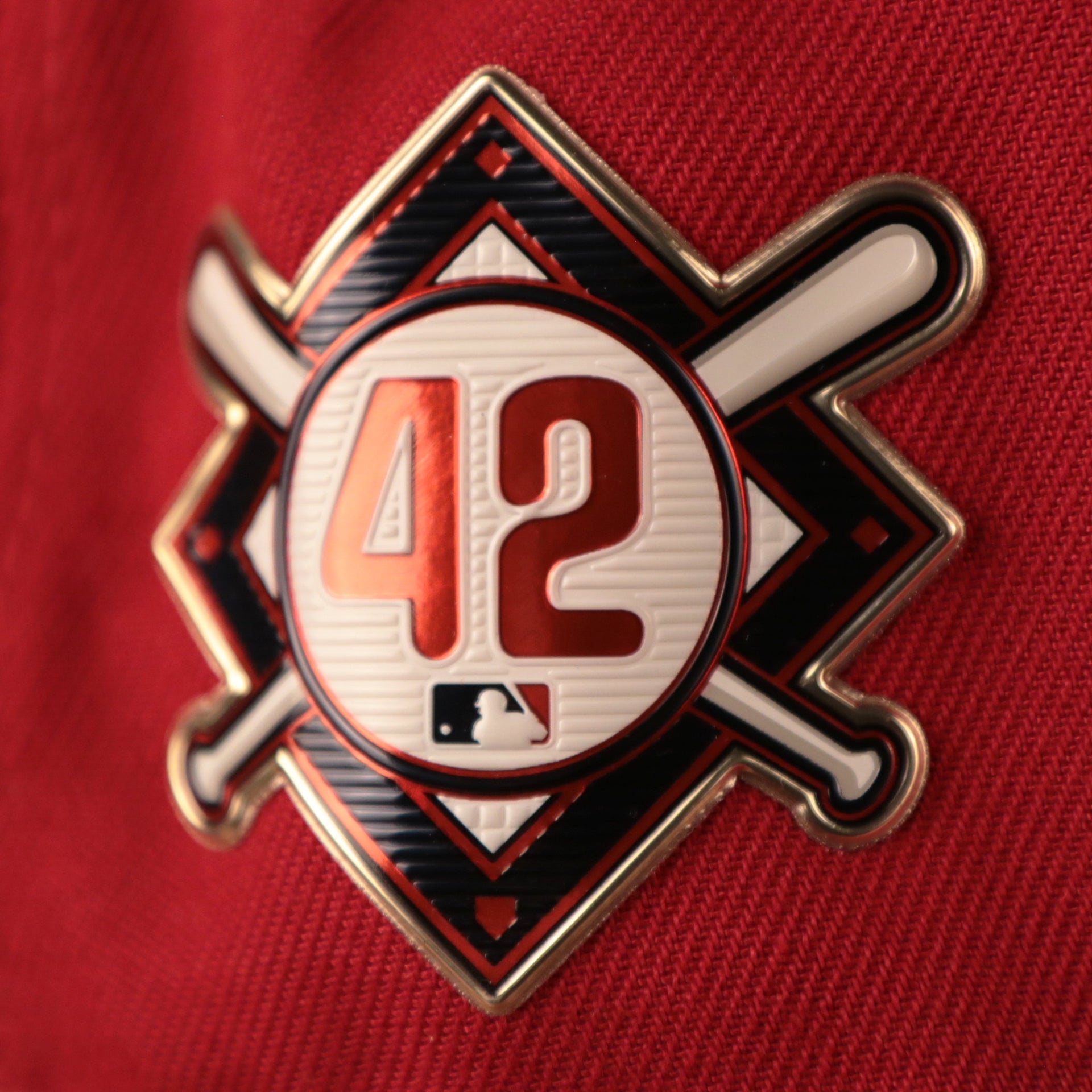 The jackie robinson patch is gold and glossy with the number 42 Phillies Jackie Robinson Fitted Cap | Philadelphia Phillies On-Field Jackie Robinson Side PatchRed Fitted Hat