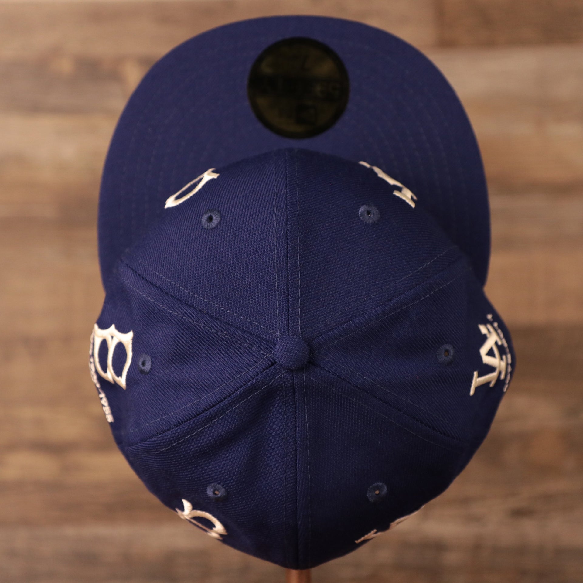 A look of the dope crown of the blue all-over logo history fitted cap by New Era.