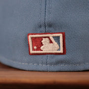 The backside of the ice blue/maroon Phillies 1980 World Series side patch fitted New Era 59fifty has the MLB logo.