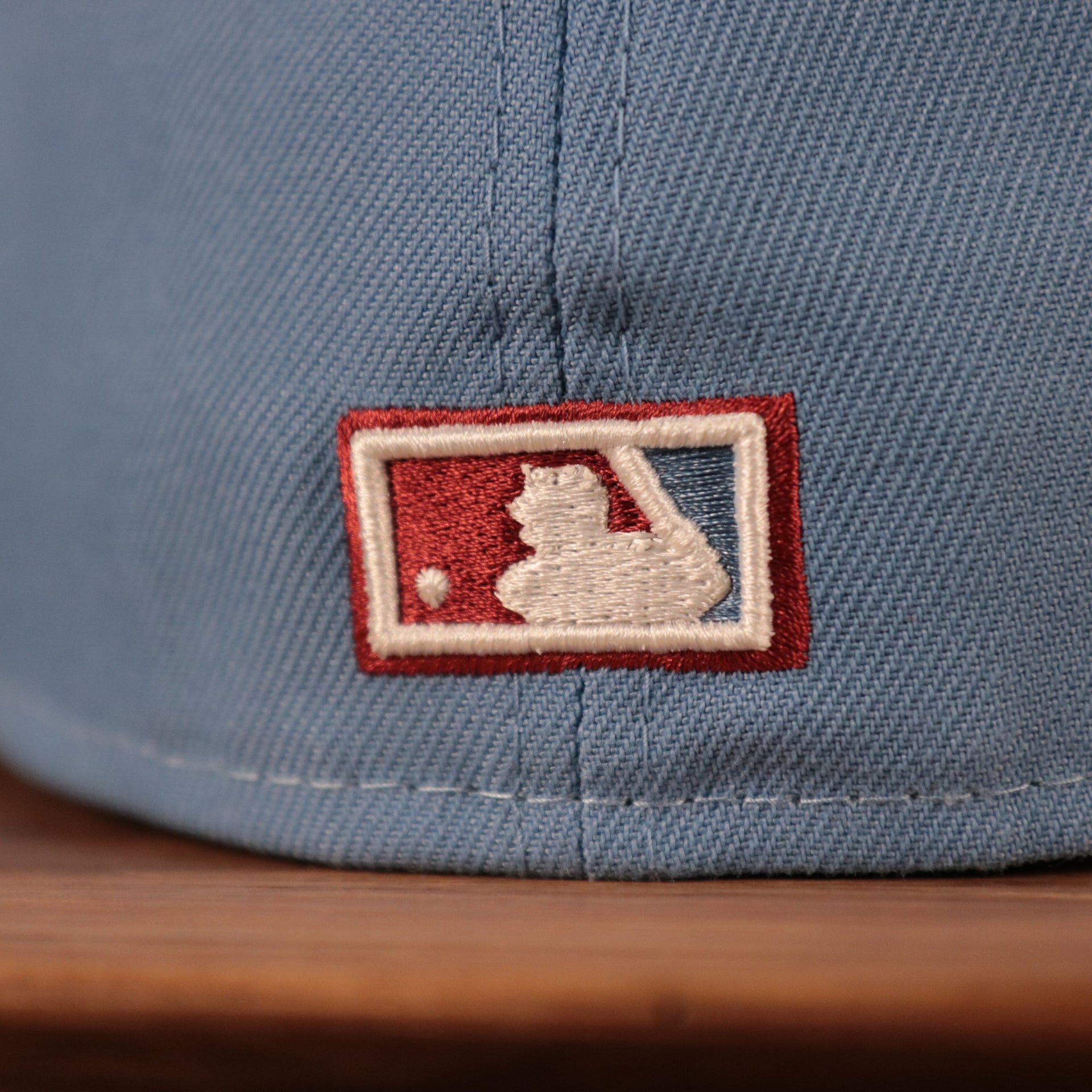 The backside of the ice blue/maroon Phillies 1980 World Series side patch fitted New Era 59fifty has the MLB logo.