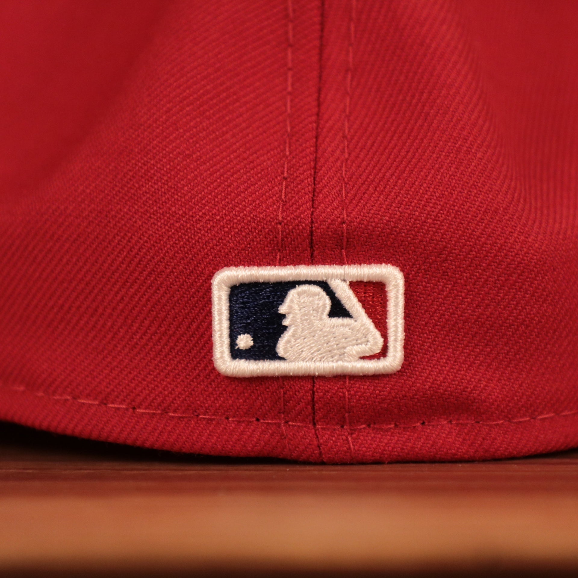 The backside of the red Philadelphia Phillies Philly Cheesesteak side patch fitted cap has the MLB logo.