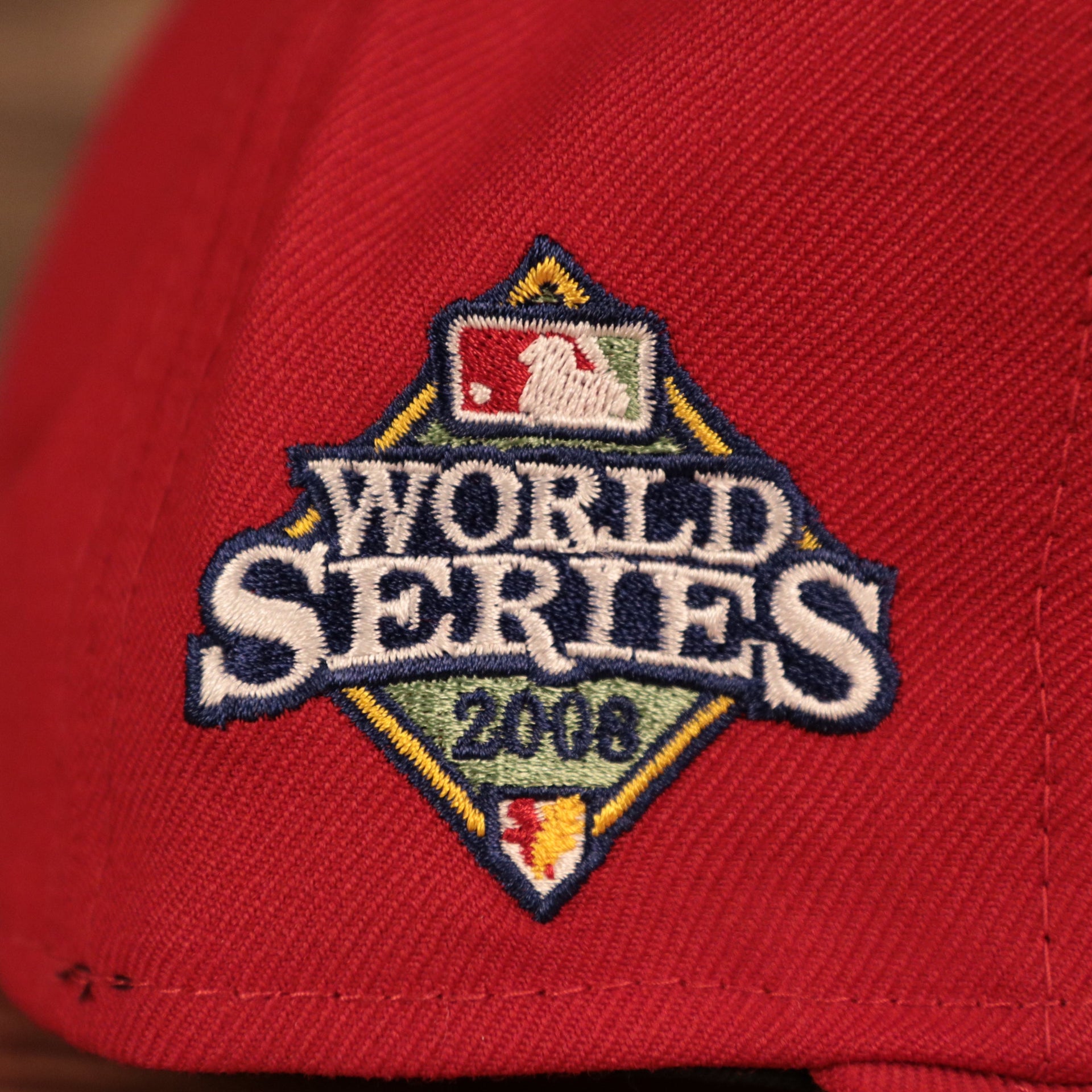 The 2008 World Series patch on the wearer's right side of the throwback Phillies 59fifty.