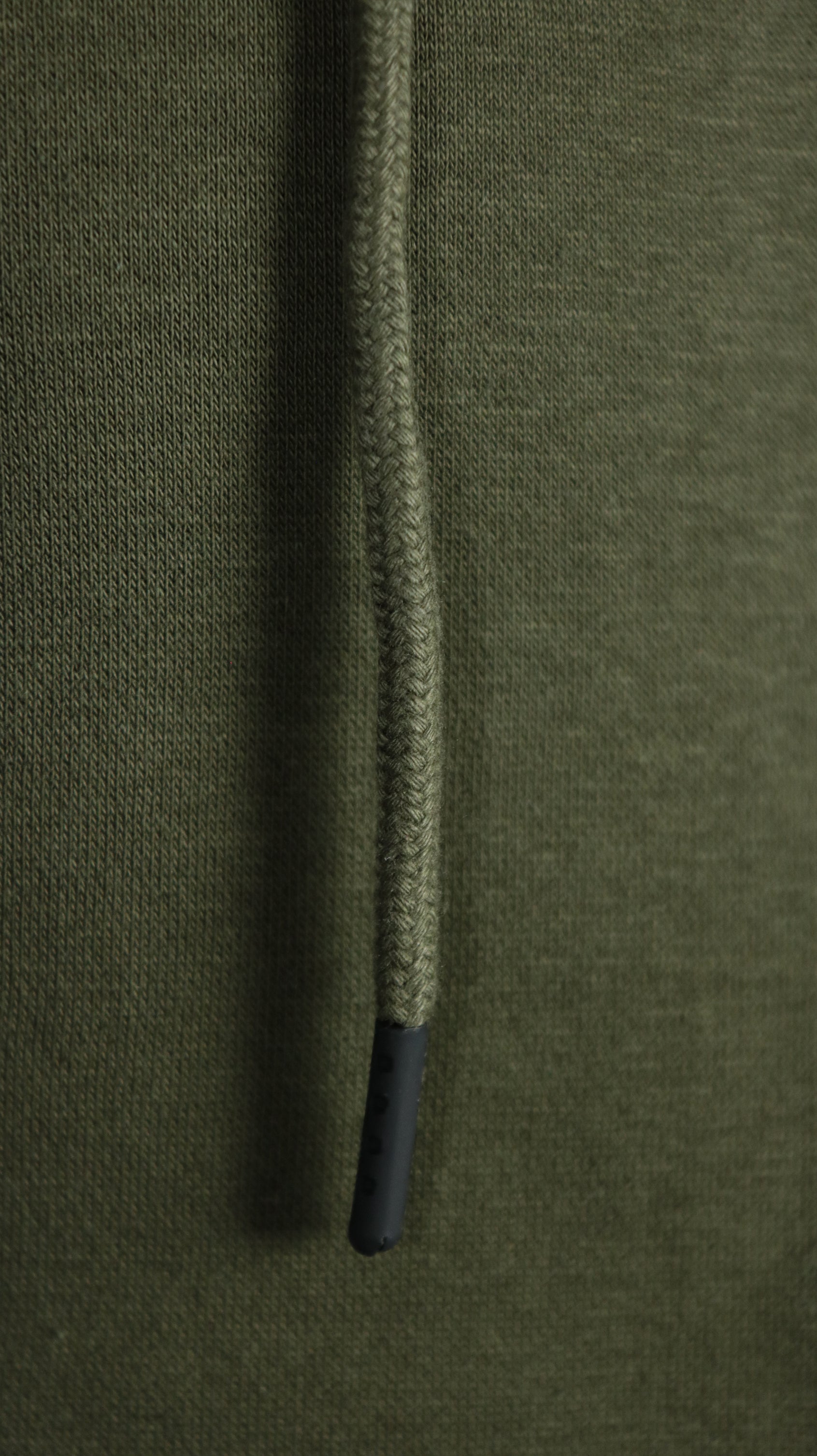 The drawstring of the military olive green zipup hoodie by Jordan Craig.