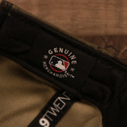 The MLB genuine merchandise tag on the inside of the woodland camo Phillies 920 dad hat.