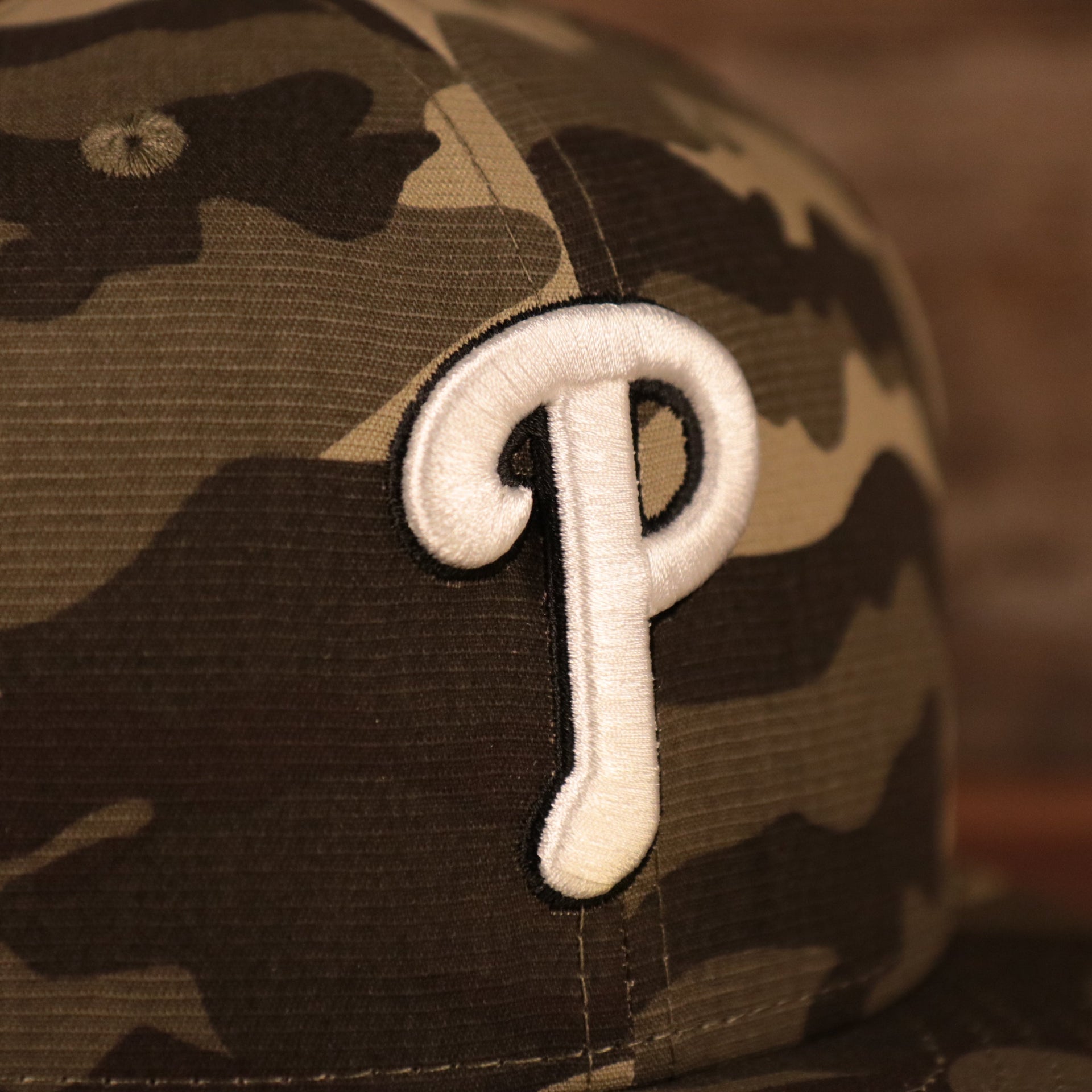 The white Philadelphia Phillies logo on the front of the Phillies Memorial Day hat 2021.