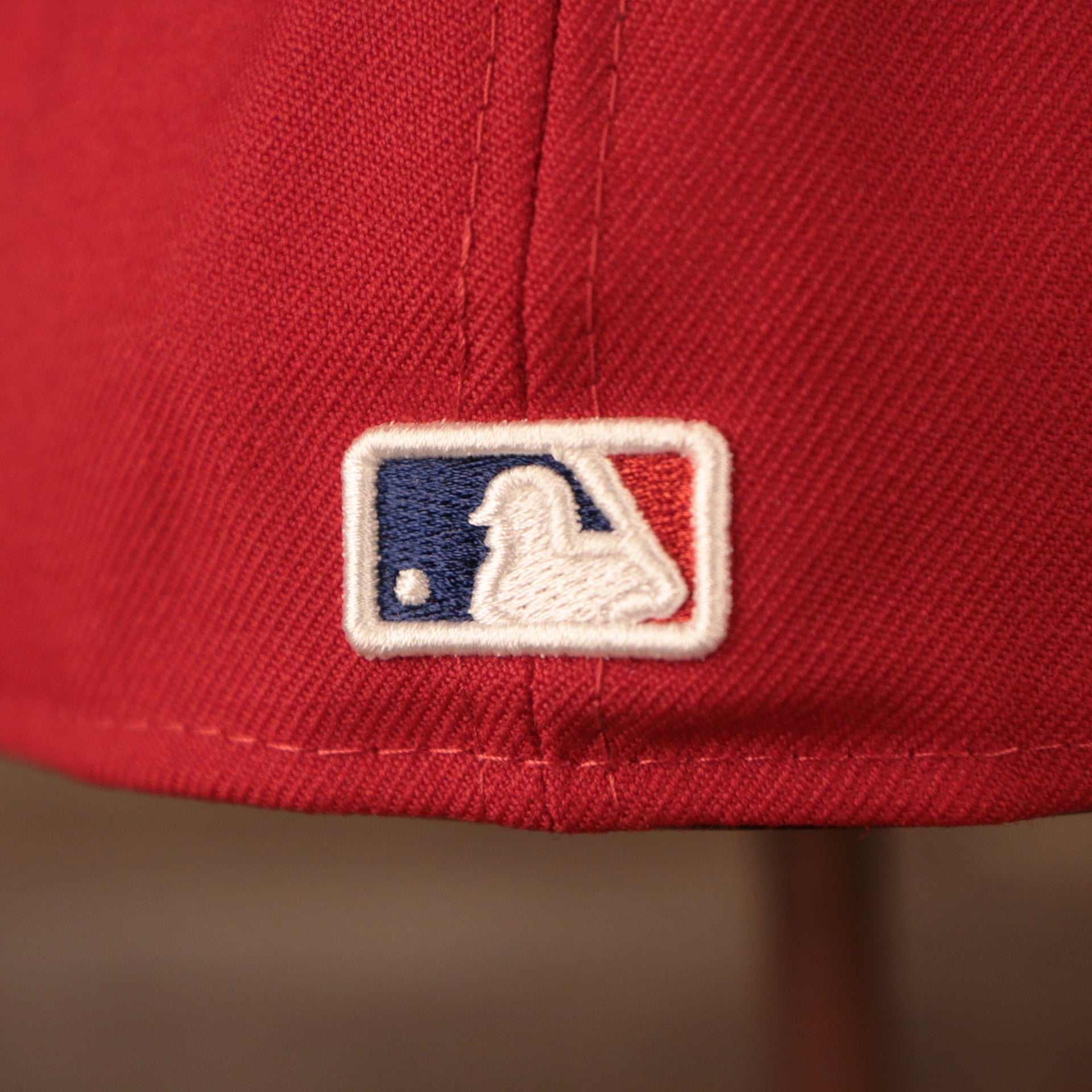 The back side of the red all over patch fitted cap by New Era has the Major League Baseball logo.