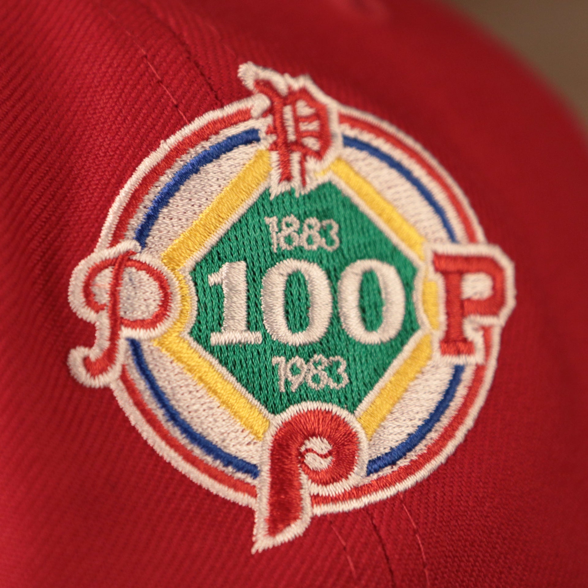 The 1883 to 1983, 100 years patch on the red all over embroidered 59fifty with gray bottom brim.