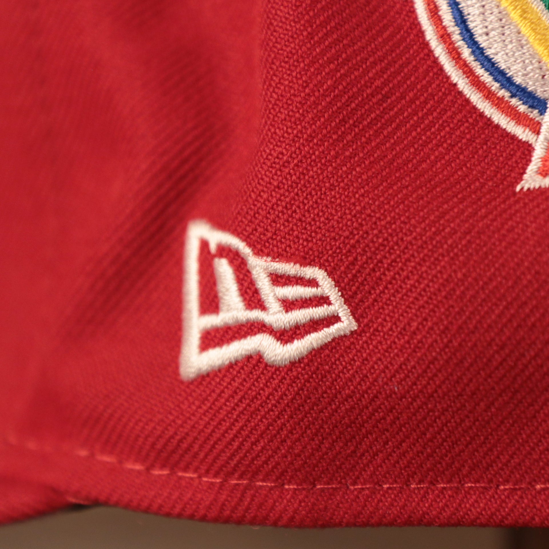 The left side of the red Phillies all over patch fitted hat has the logo of New Era in white.