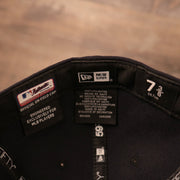 Woven labels showing the details, authentic tag, the New Era brand, and the size of the NY Yankees 59Fifty Black Bottom Cap