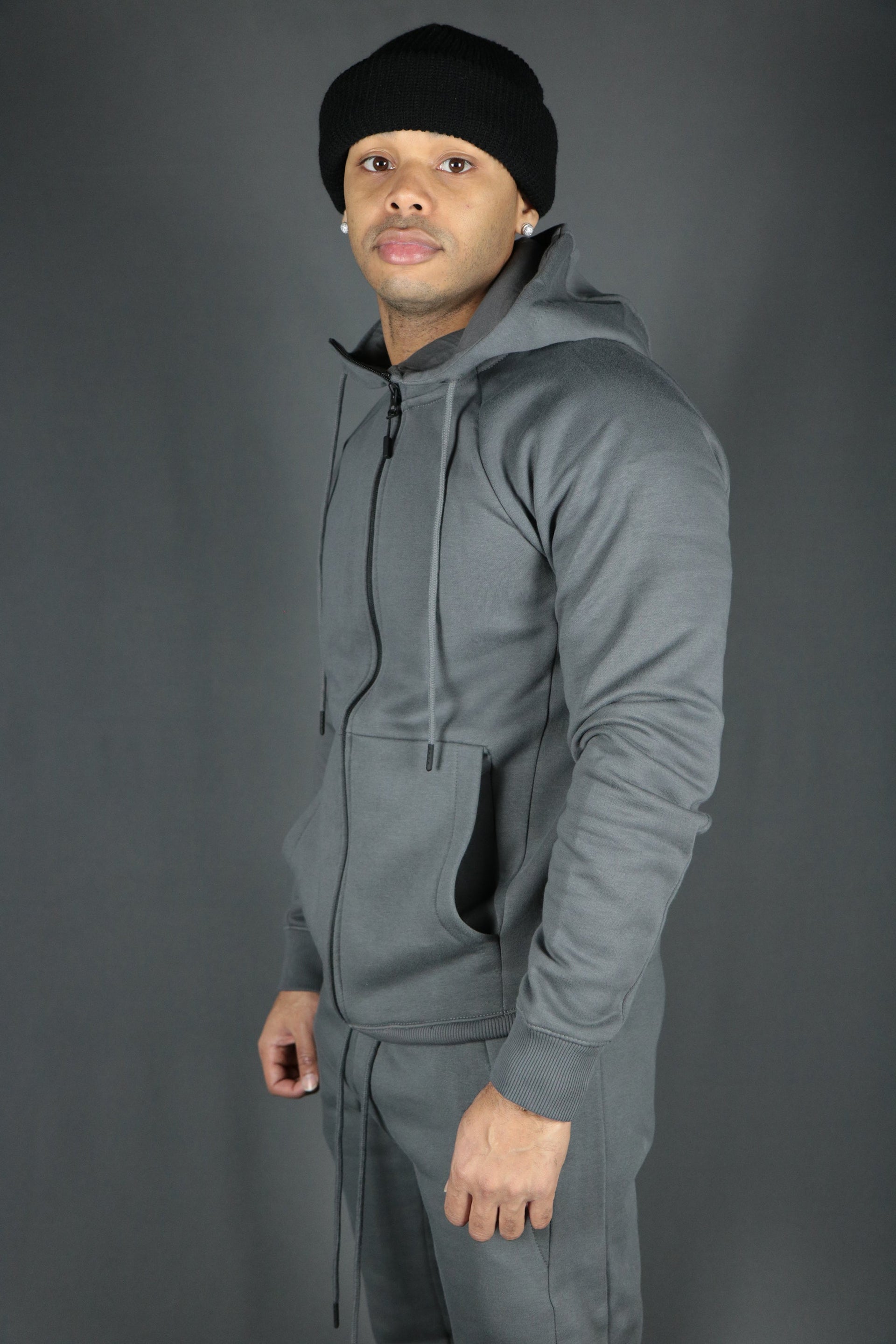 A model sporting the charcoal basic fleece zipped hoodie with Jordan Craig charcoal sweatpants.