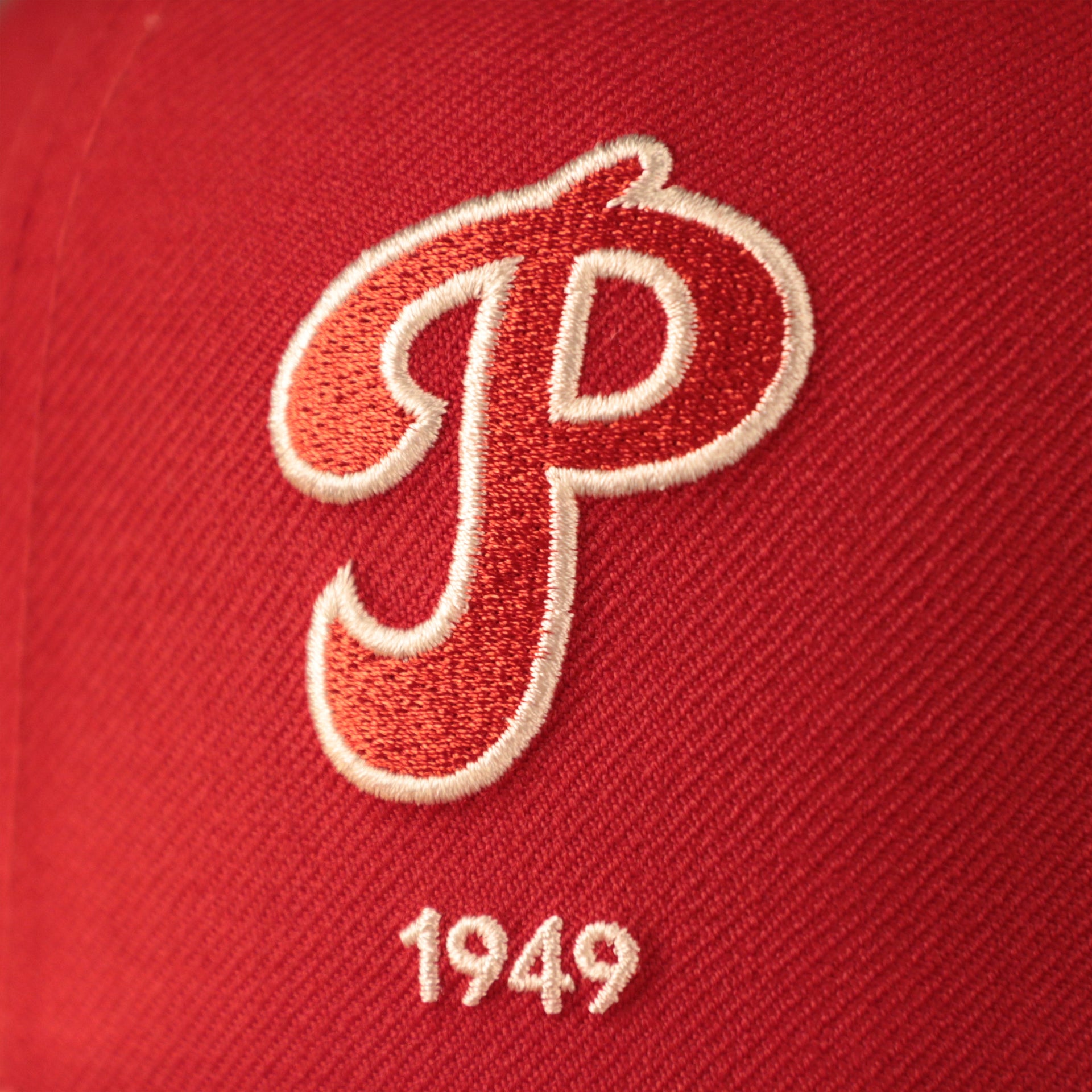 The red 1949 logo of the fighting Phils on the red patch fitted hat for the team by New Era.