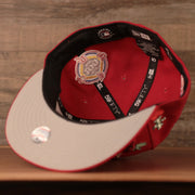 The grey bottom brim of the red all over patch fitted hat for the Philadelphia Phillies by New Era.