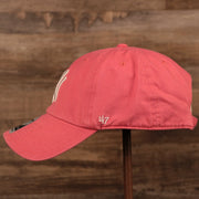 The left side of the pink New York Yankees green bottom adjustable hat by 47 Brand.