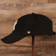 The left side of the black New York Yankees pink bottom adjustable hat.