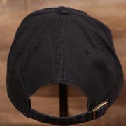 The adjustable strap of the navy blue cotton pink bottom clean up cap.