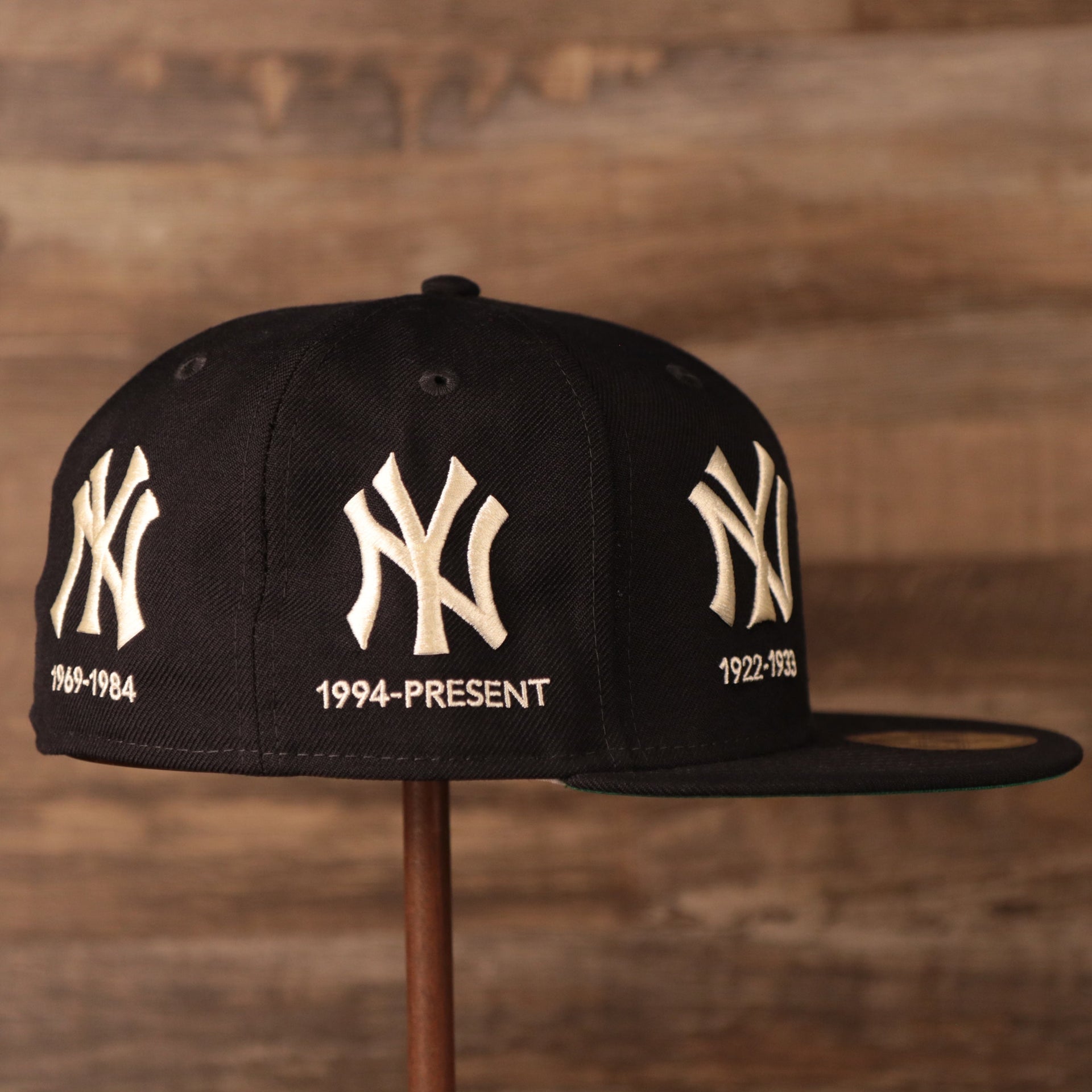 A navy 59fifty designed with an all-over patch fitted of the New York Yankees logo history by New Era.