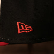 The logo of New Era on the right side of the black luchadores de reading fitted cap.