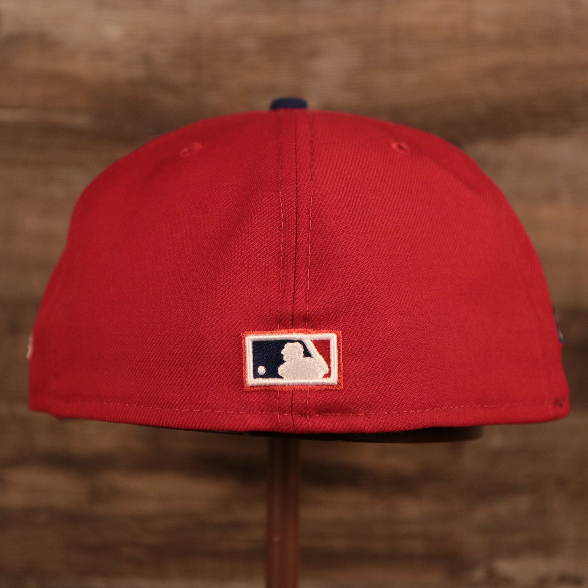 The backside of the red Phillies side patch fitted New Era 59fifty has the MLB logo.