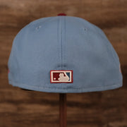 The MLB logo on the backside of the ice blue/maroon World Series 1980 Philadelphia Phillies gray bottom brim fitted cap by New Era.